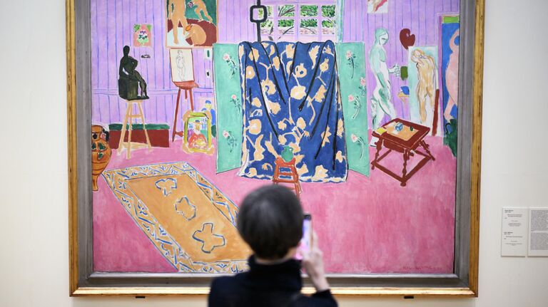 Журналист около картины художника А.Маттиса Мастерская художника на пресс-показе фокус-выставки Матисс и Пикассо. Цвет и форма в Третьяковской галерее