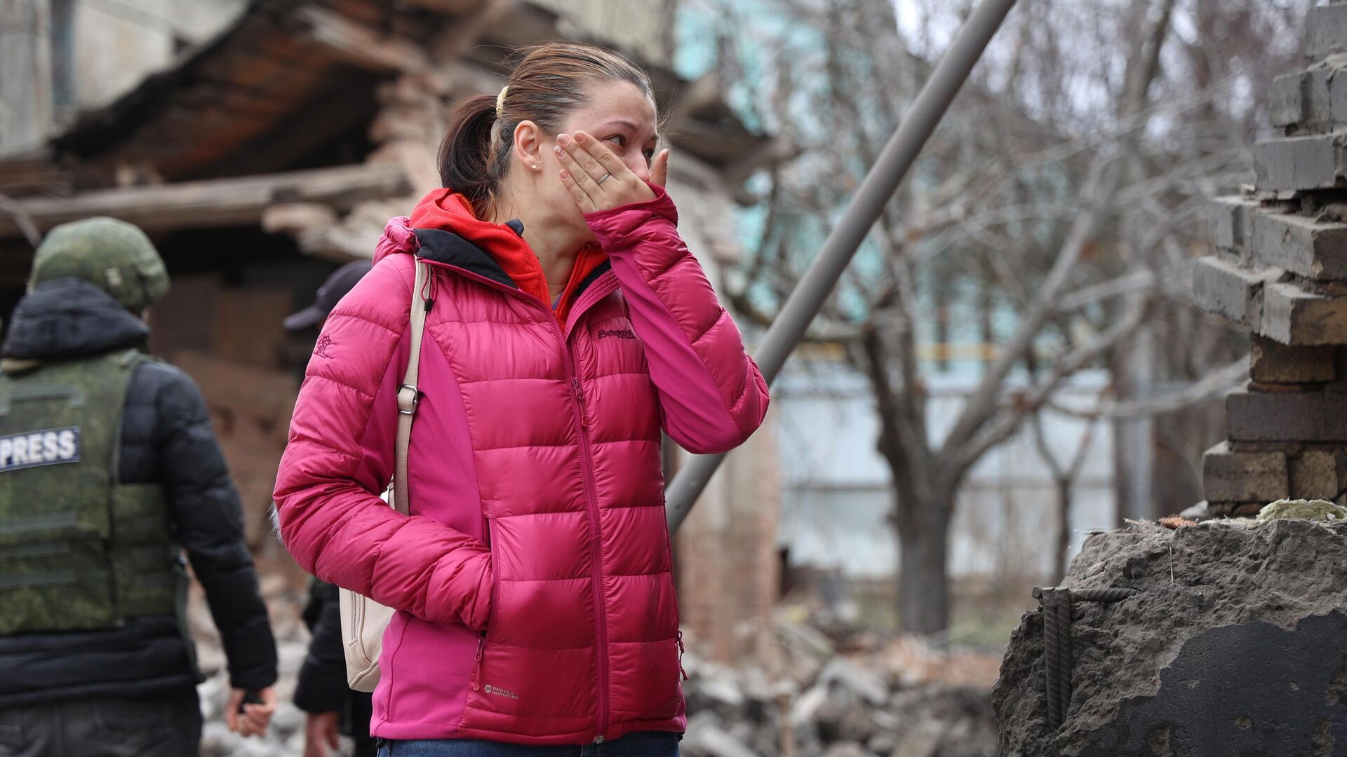 Woman near her house damaged by Ukrainian shelling in Donetsk